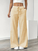 Striped wide-leg trousers in yellow, front view