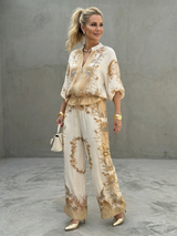 Zip-front blouson top and printed wide-leg trouser set, front view