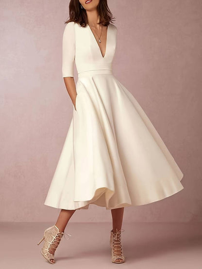 Flared midi dress showing elbow-length sleeves