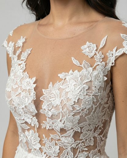 Close-up of floral lace bodice detail on white maxi dress