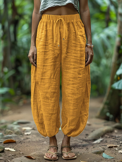 Dark green lantern trousers showing ankle gather detail