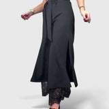 Wide-leg trousers with lace accent in black, front view