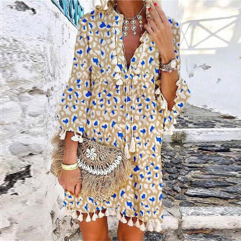 Boho mini dress showing tassel detail and bell sleeves
