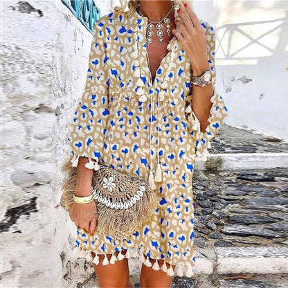 Boho mini dress showing tassel detail and bell sleeves