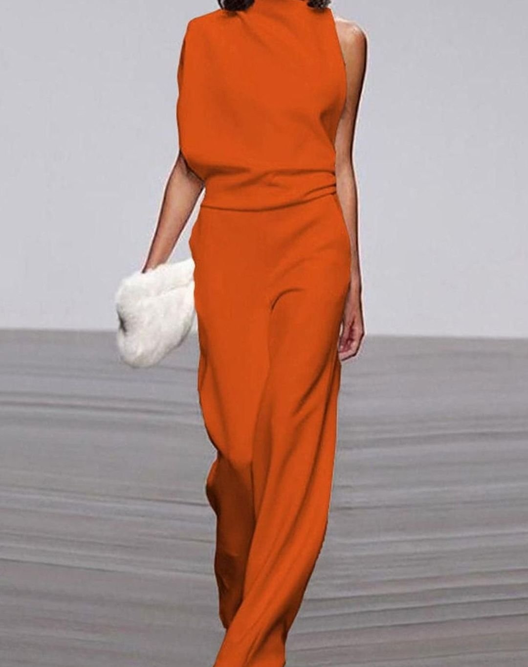 Asymmetric high-neck wide-leg formal jumpsuit, close-up of the fabric