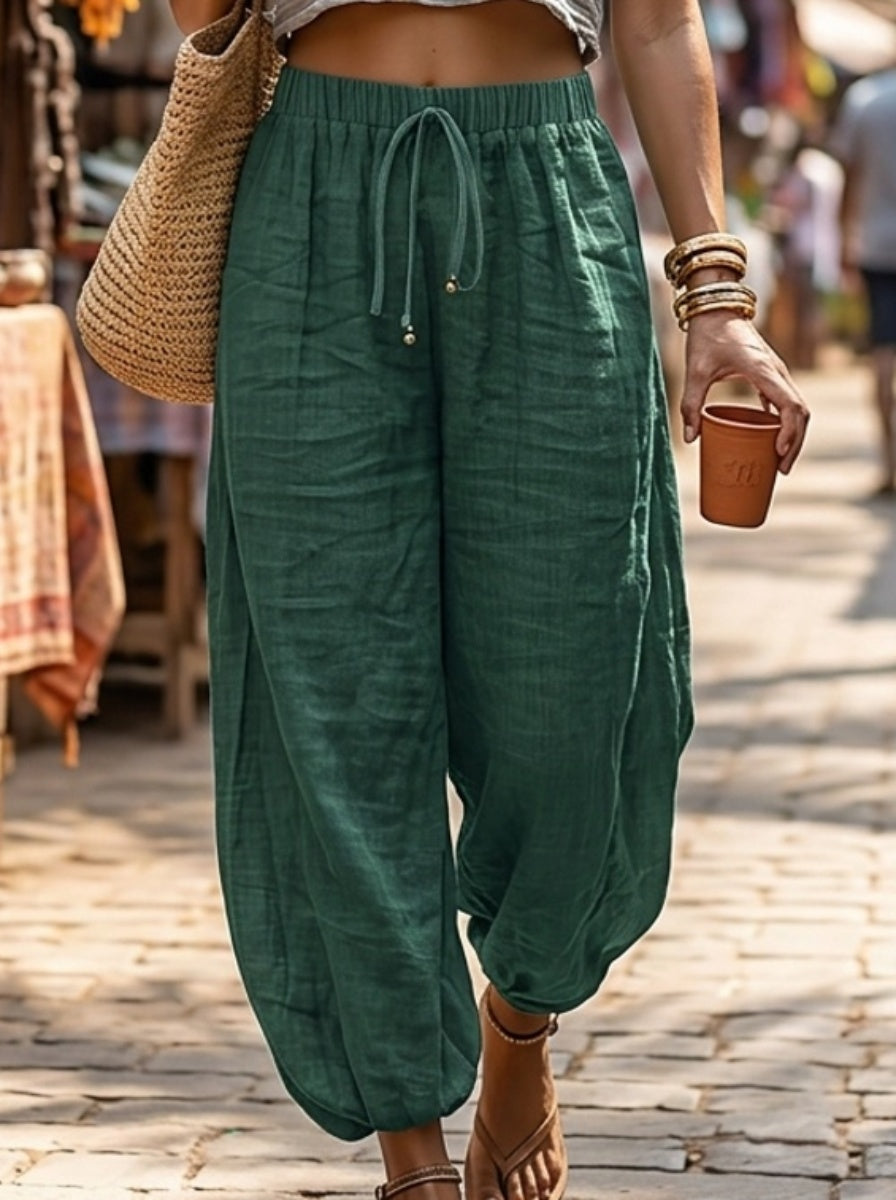 Relaxed drawstring lantern trousers in dark green, front view