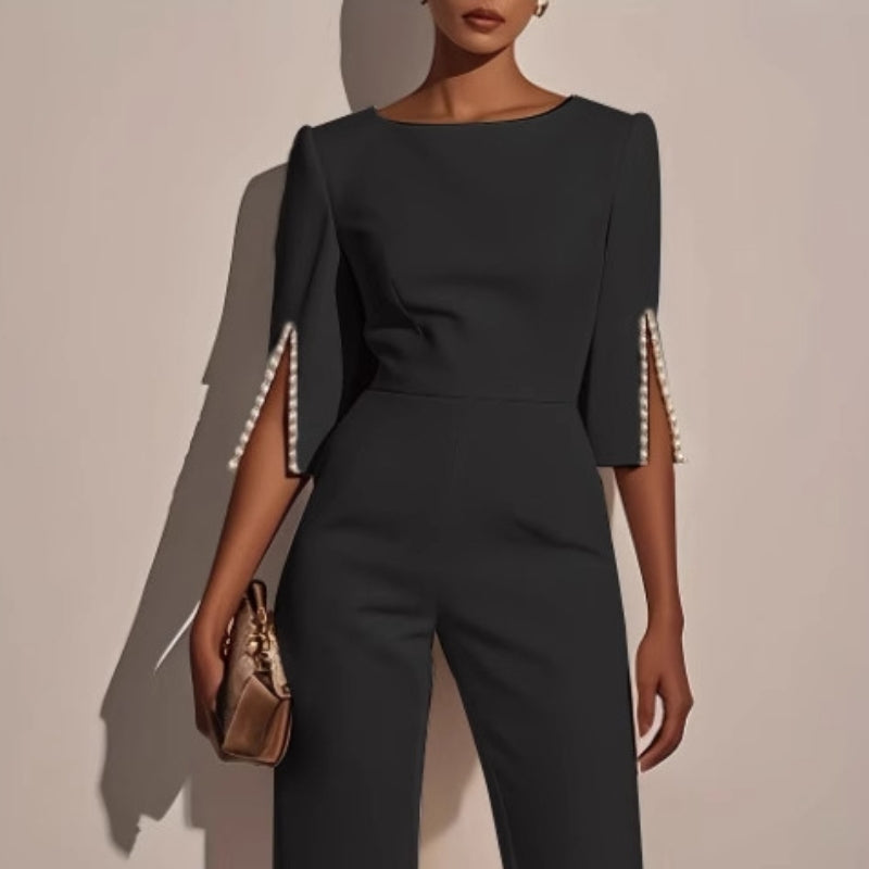 Wide-leg jumpsuit with pearl trim, close-up of the neckline