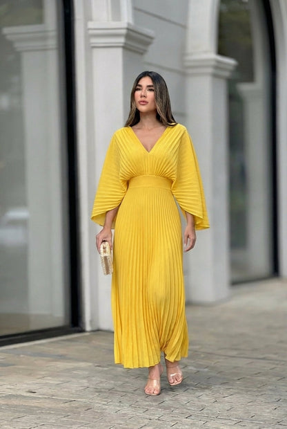 Pleated V-neck gown with flowing sleeves, side view