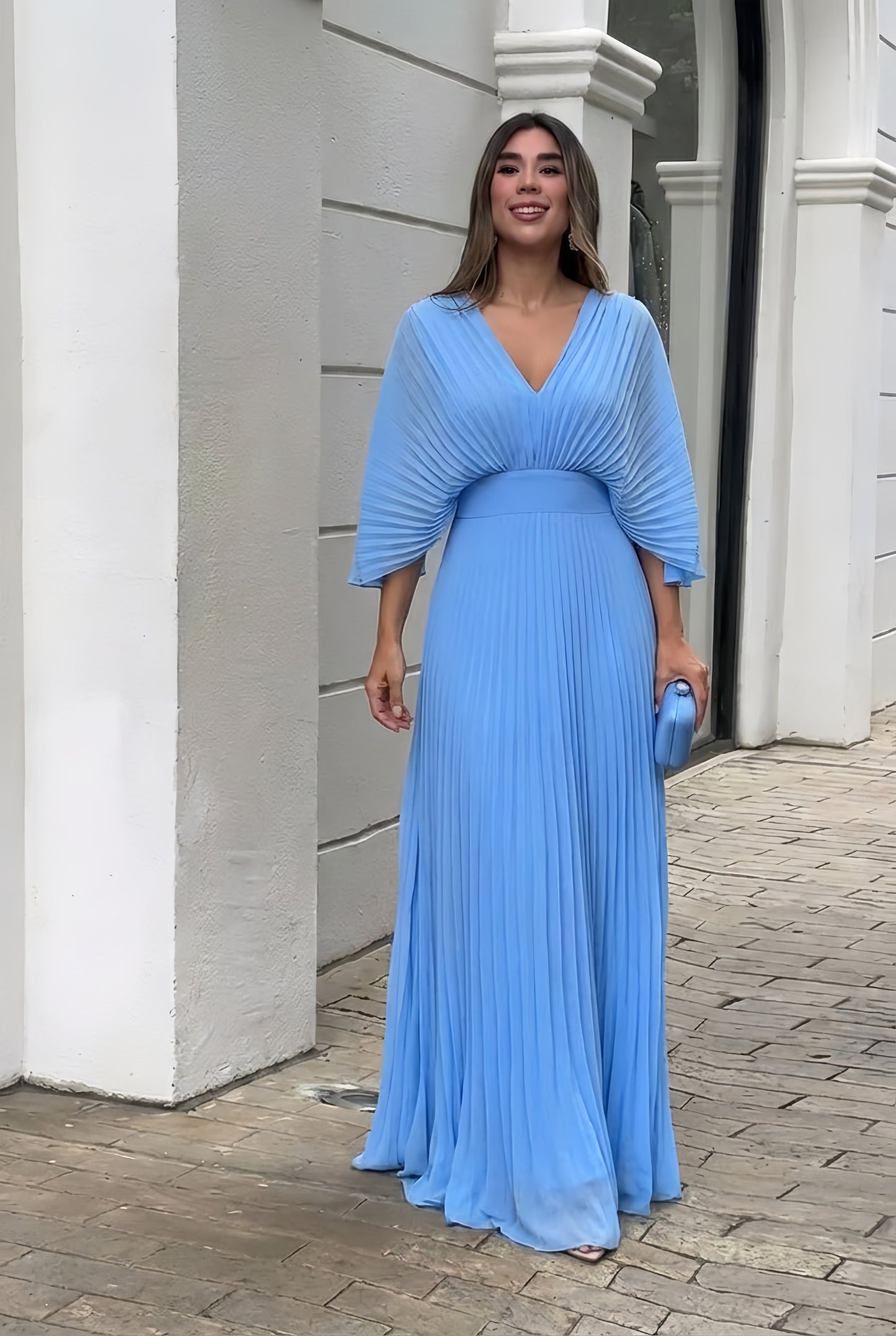 Pleated maxi gown showing defined waist