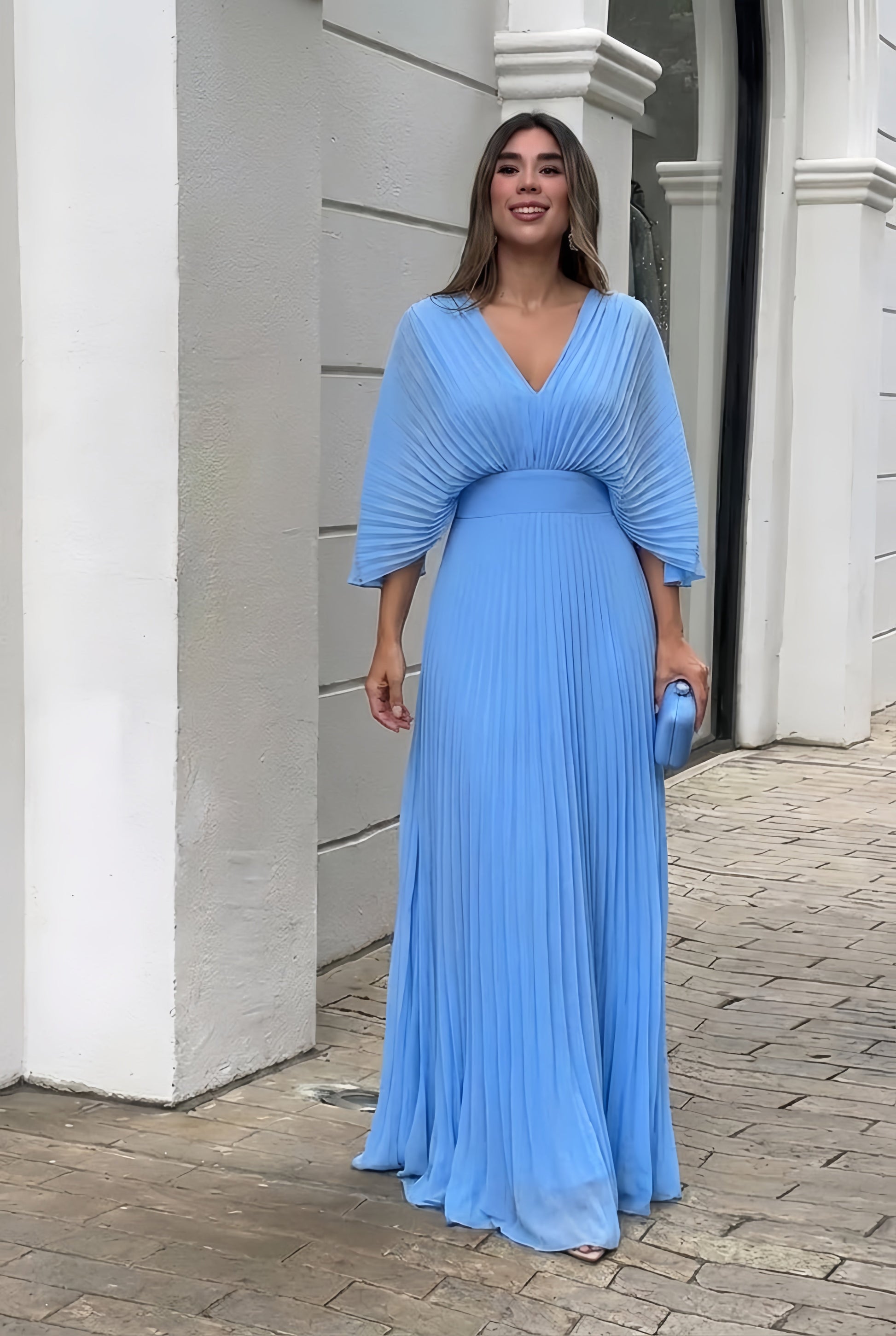 Pleated maxi gown showing defined waist